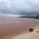 The contaminated water in Kangava Bay bleeds red.